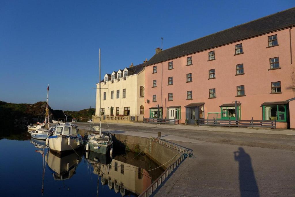 a group of boats are docked in front of a building at The Clady in Bunbeg