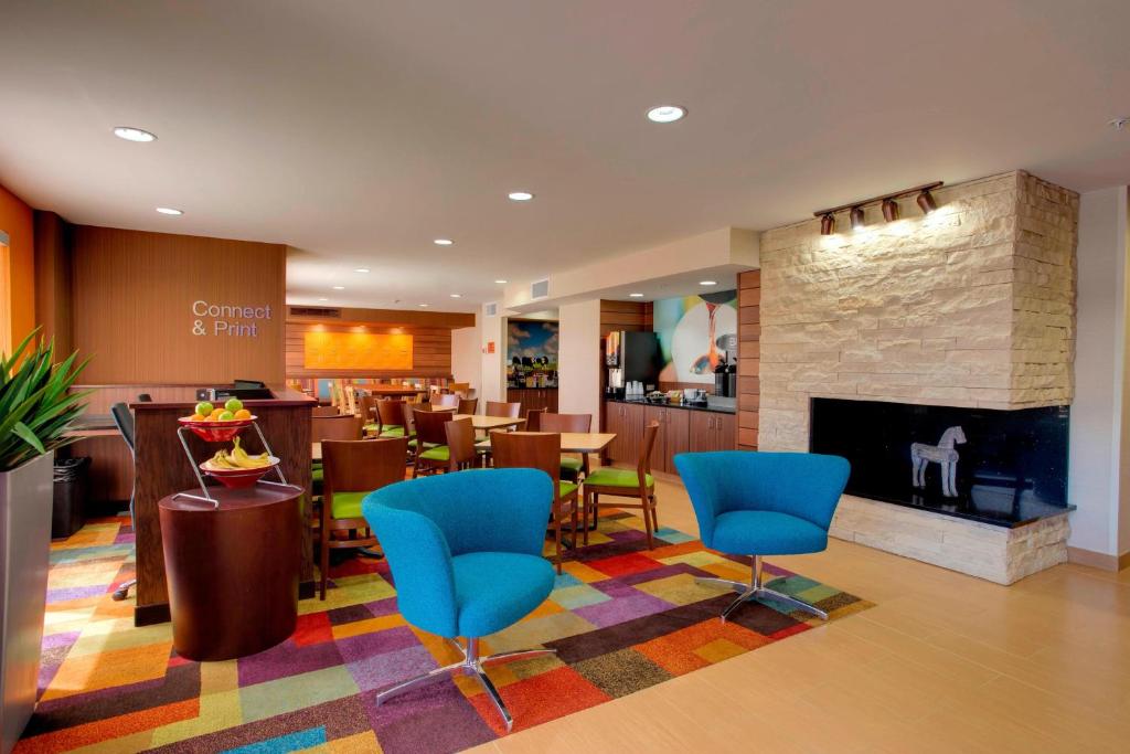 a restaurant with blue chairs and a fireplace at Fairfield Inn by Marriott Las Cruces in Las Cruces