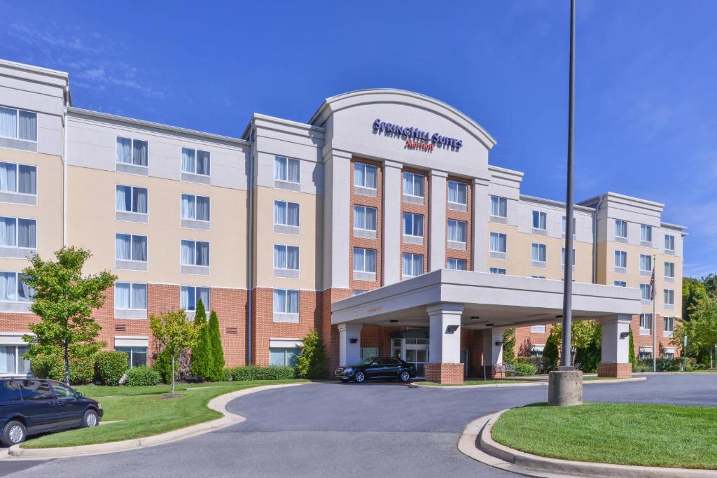 a hotel building with a car parked in front of it at SpringHill Suites Arundel Mills BWI Airport in Hanover