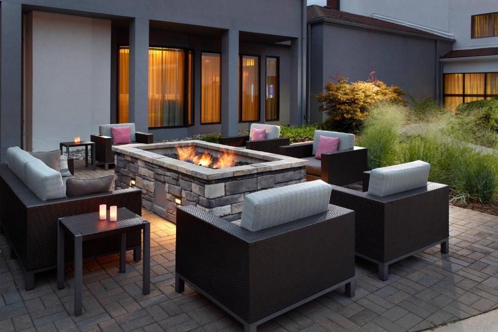 a patio with couches and a fire pit at Courtyard by Marriott Raleigh Cary in Cary