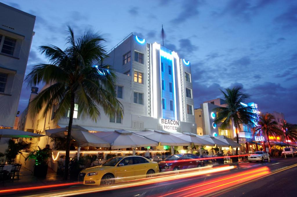 a large building with a clock on the side of it at Beacon South Beach Hotel in Miami Beach