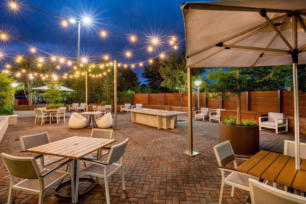 a patio with tables and chairs and lights at Delta Hotels by Marriott Chesapeake Norfolk in Chesapeake