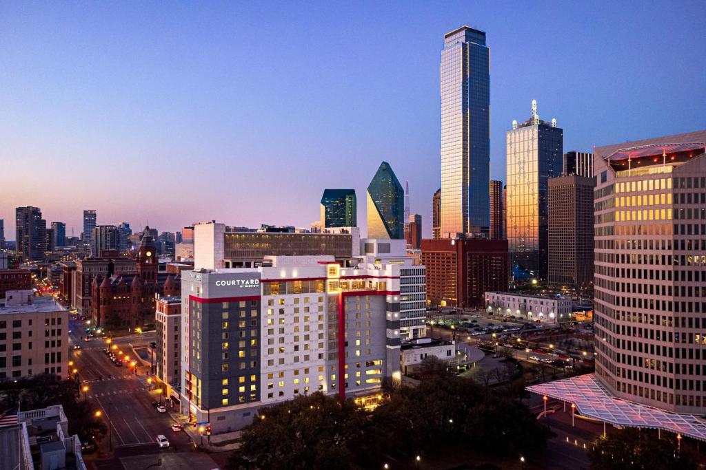 a view of a city skyline at night at Courtyard by Marriott Dallas Downtown/Reunion District in Dallas