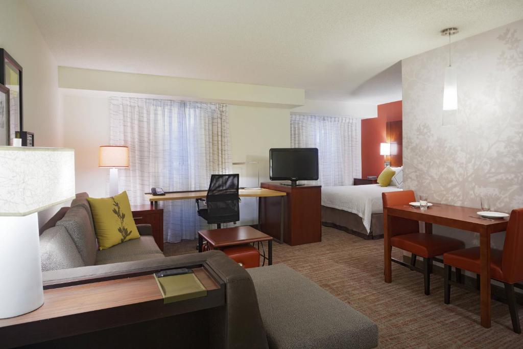 a hotel room with a couch and a bed at Residence Inn by Marriott San Antonio Downtown Market Square in San Antonio