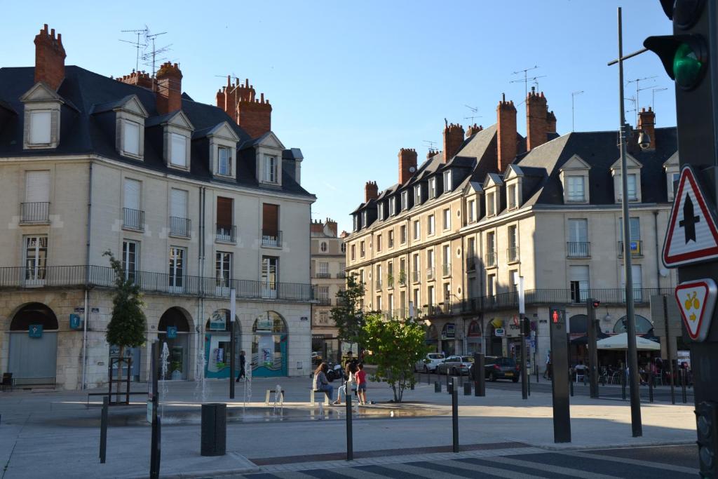 a city street with buildings and people walking on the street at Entre Loire et Chateau in Blois