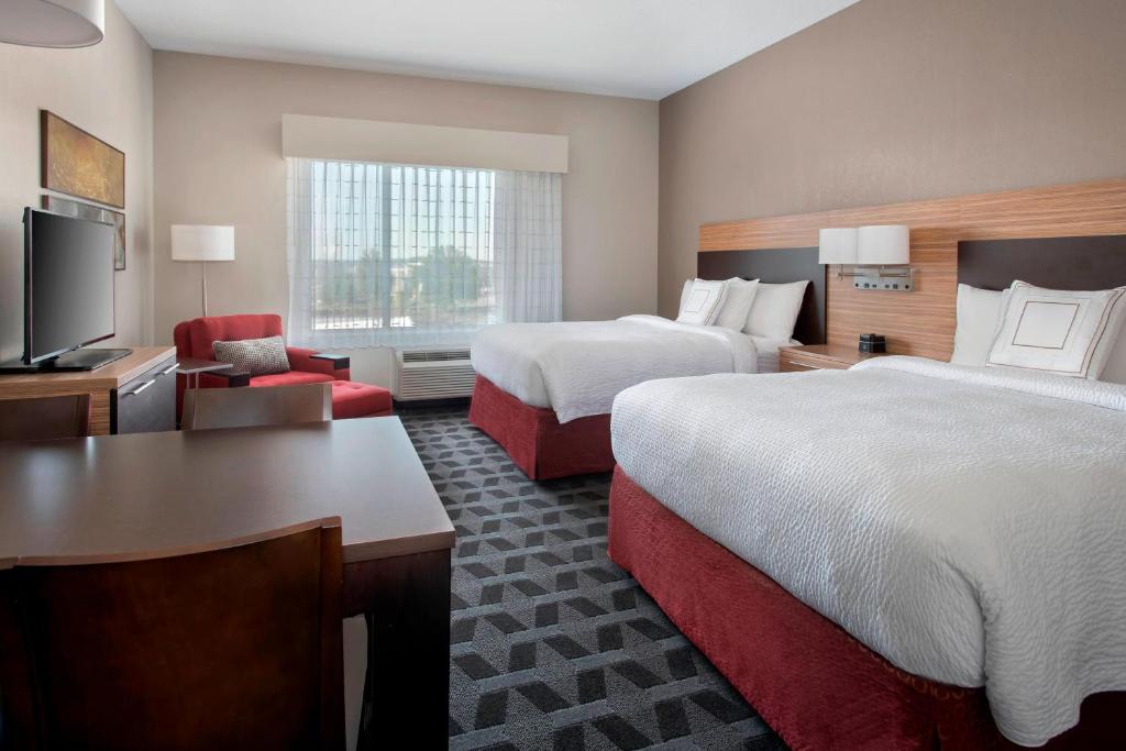 a hotel room with two beds and a television at TownePlace Suites by Marriott Nashville Goodlettsville in Goodlettsville