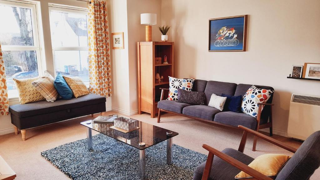 a living room with a couch and a coffee table at Beauly Holiday Home in Beauly