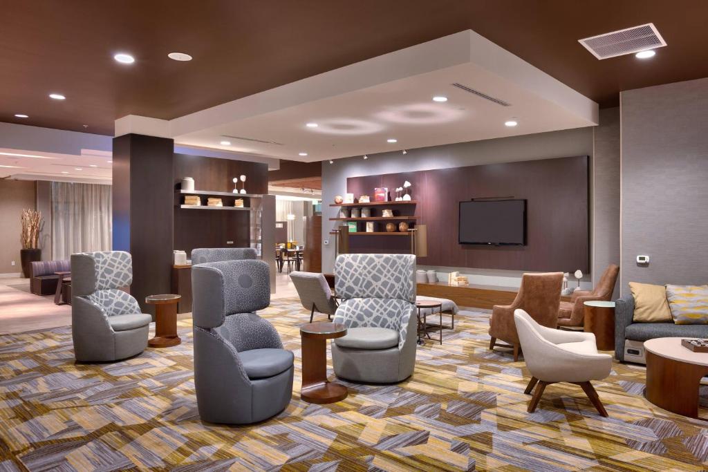 a waiting room with chairs and a flat screen tv at Courtyard by Marriott Salt Lake City Downtown in Salt Lake City
