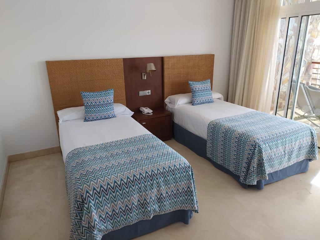 Postel nebo postele na pokoji v ubytování Anfi del Mar 2