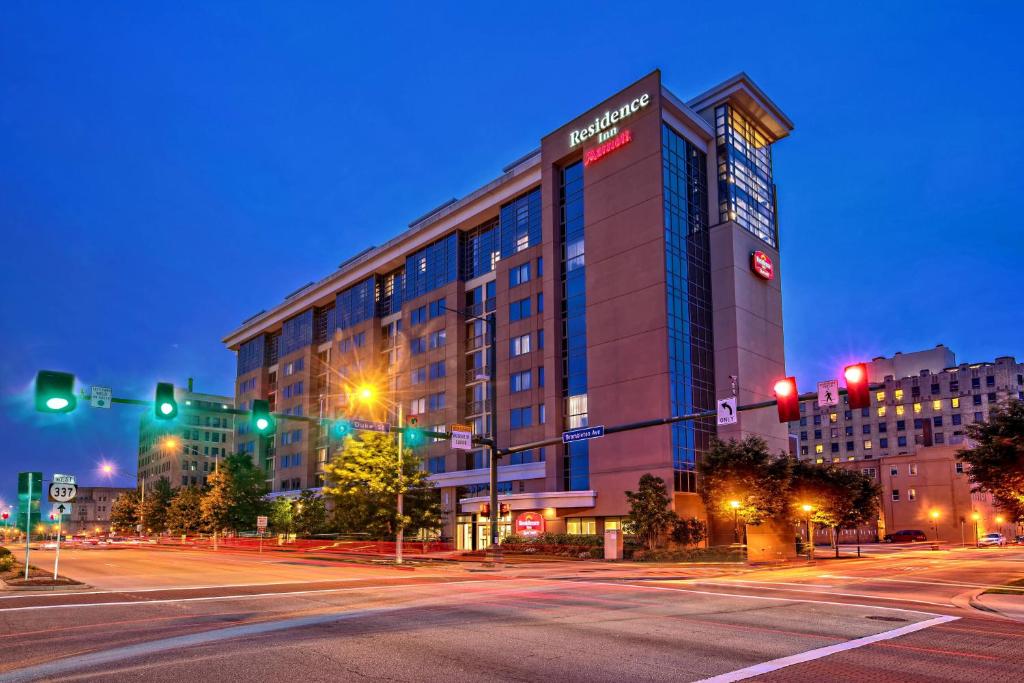 a large building on a city street at night at Residence Inn Norfolk Downtown in Norfolk