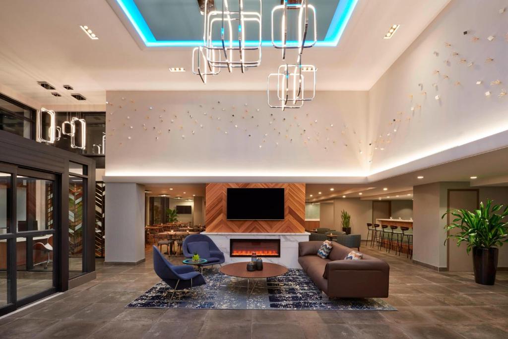 a living room with a couch and a tv at Fairfield Inn by Marriott Montreal Downtown in Montréal