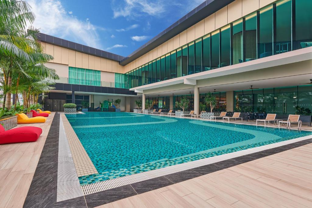 a swimming pool in front of a building at Four Points by Sheraton Desaru in Desaru