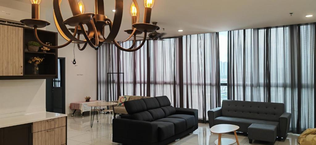 a living room with a couch and a chandelier at Petaling Jaya Atria Sofo Suite in Petaling Jaya