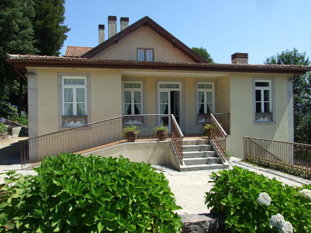 a house with a porch and stairs in front of it at Casa de Valdemar in Felgueiras