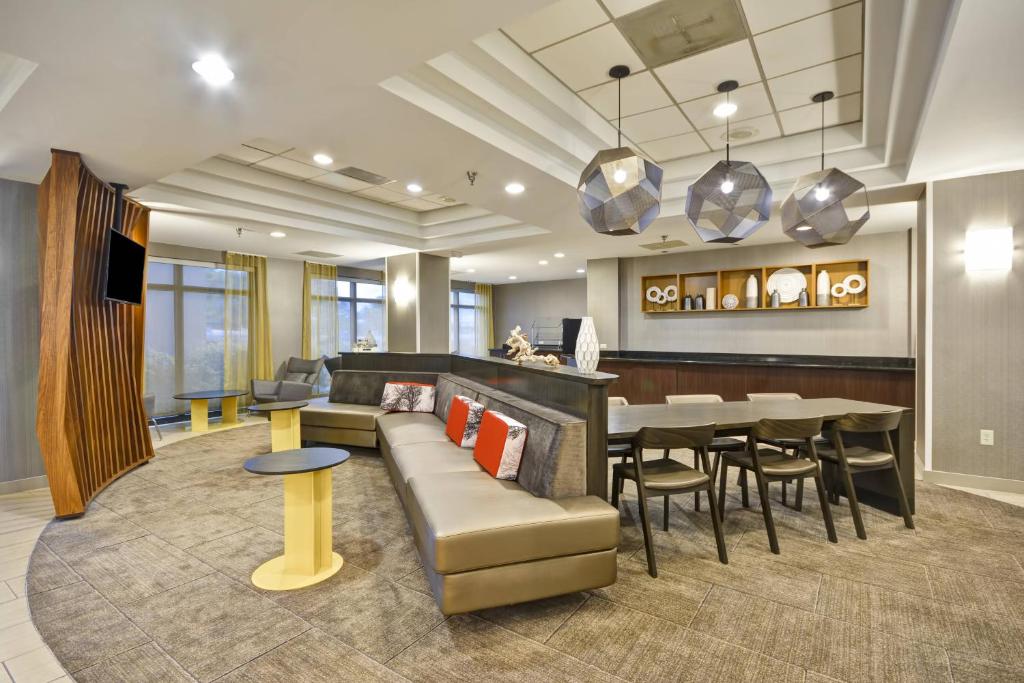 a living room with a couch and a dining room at SpringHill Suites by Marriott San Antonio Medical Center/Northwest in San Antonio