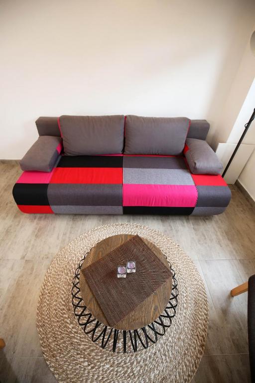 a couch in a living room with a table at NeRea Apartment Molat in Molat