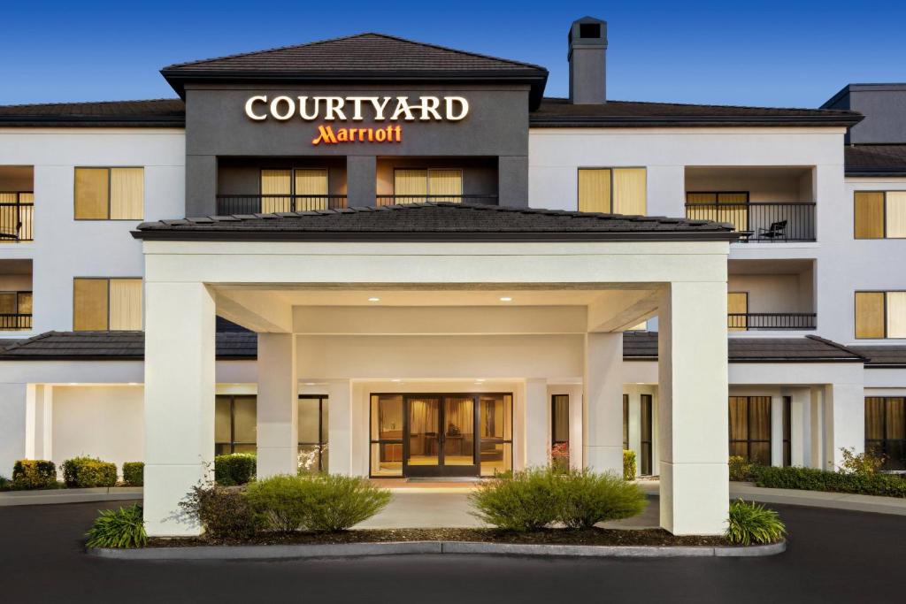a rendering of the front of a court yard apartment building at Courtyard by Marriott Roseville in Roseville