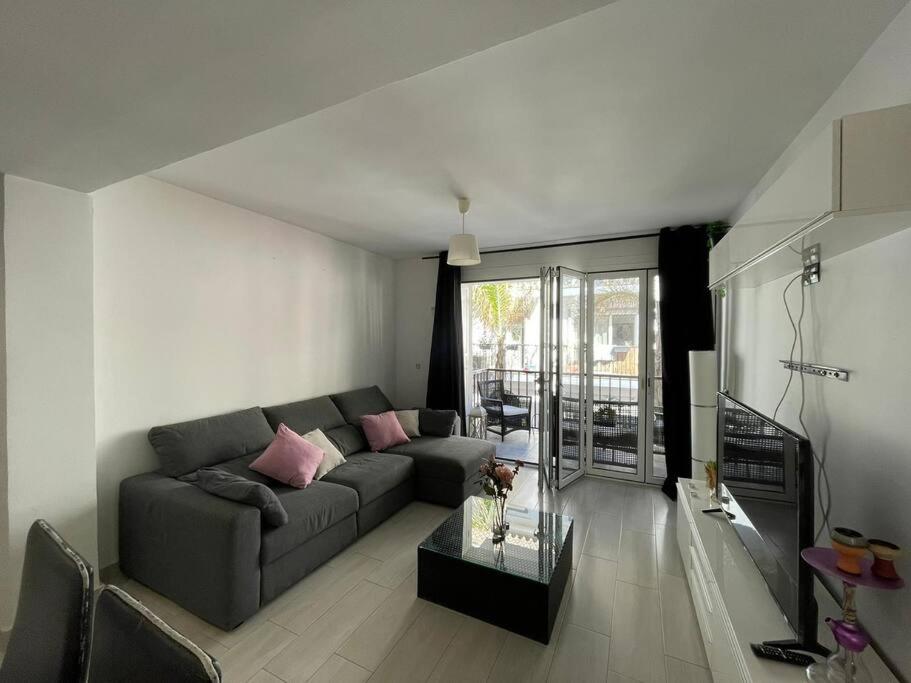 a living room with a couch and a table at Apartamento playa Fuengirola centro paseo marítimo in Fuengirola