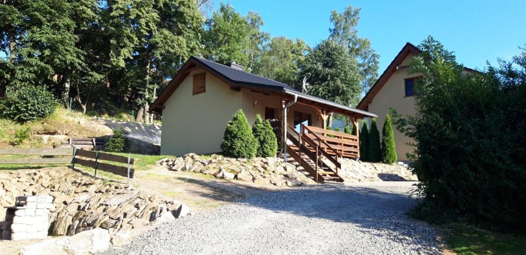 a house with a pile of rocks in front of it at Domek w Karkonoszach 1 pod Karpaczem in Karpacz
