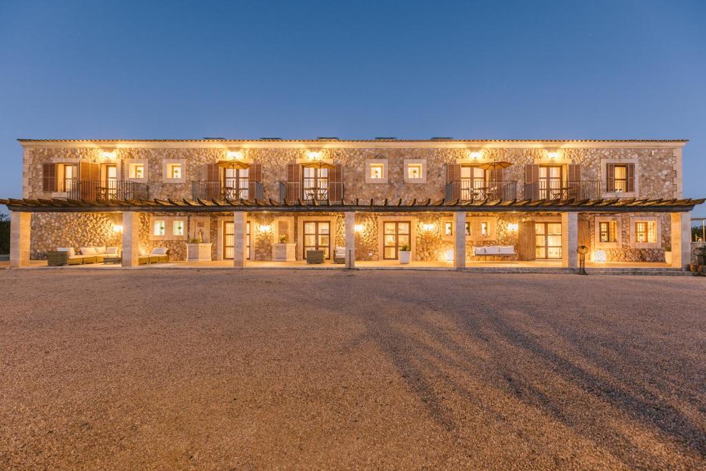 a large stone building with lights on it at Antonias Finca Agroturismo Adults Only in Santa Maria del Camí