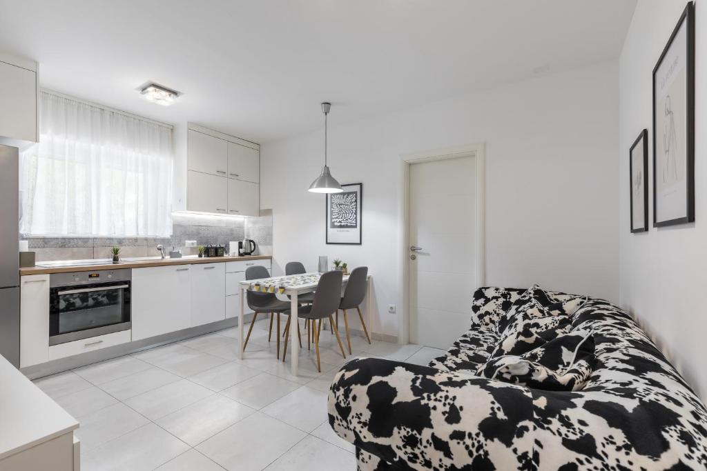a kitchen and living room with a couch and a table at Cool Suite in Split