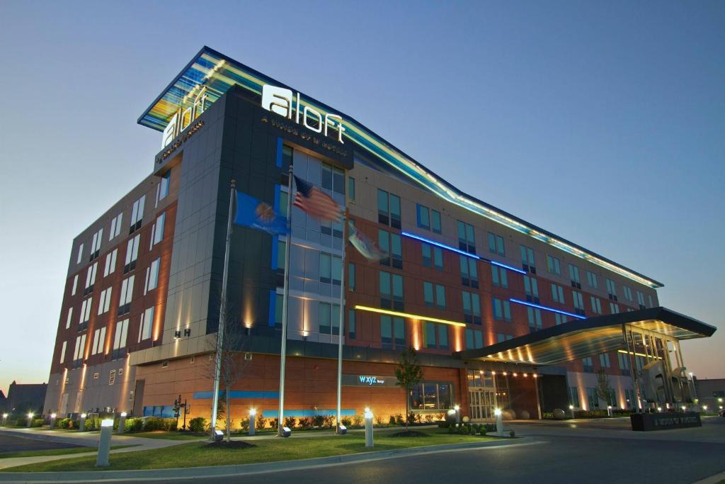 a hotel with a sign on the side of it at Aloft Tulsa in Tulsa