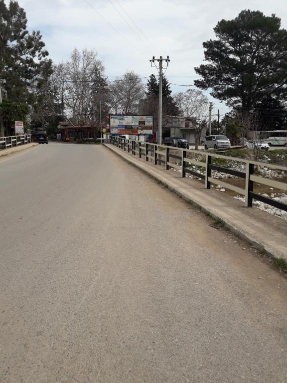 an empty road next to a wooden fence at KARAVAN in Kemer