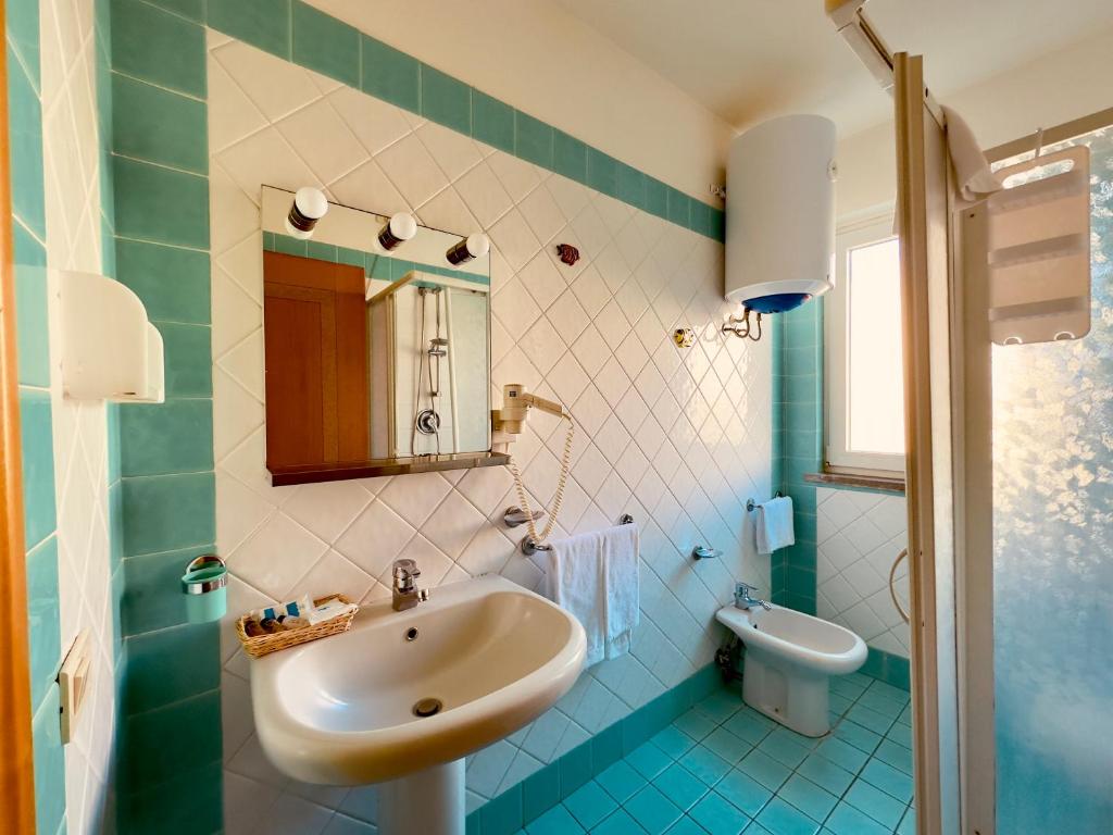 a bathroom with a sink and a toilet at Baia di Talamone in Talamone