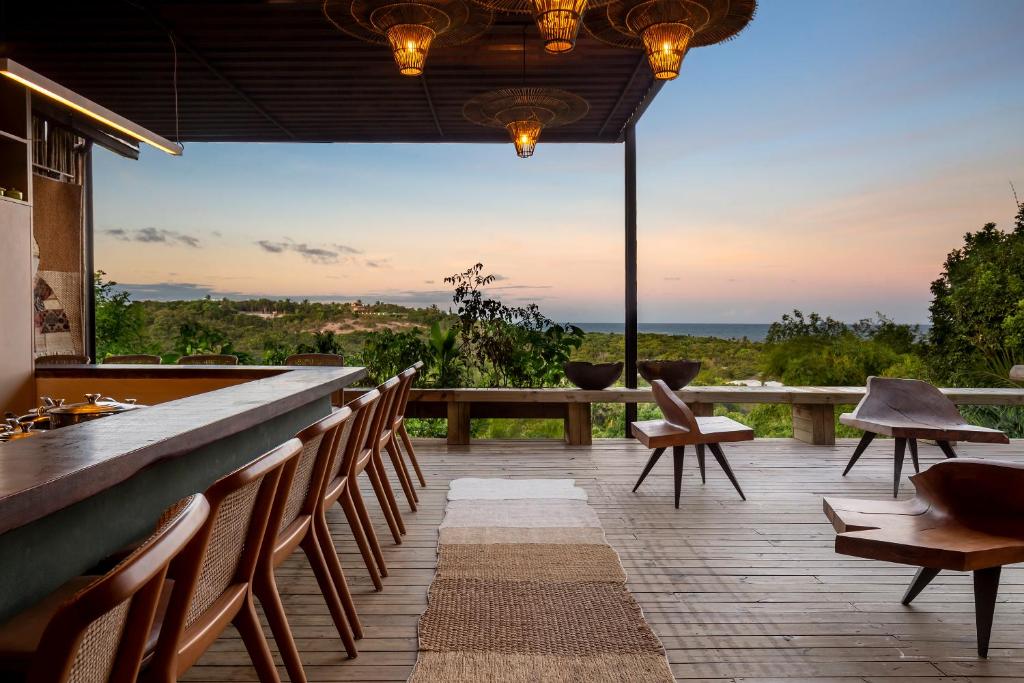 a patio with chairs and a bar with a view at Alma Ninho Trancoso in Trancoso