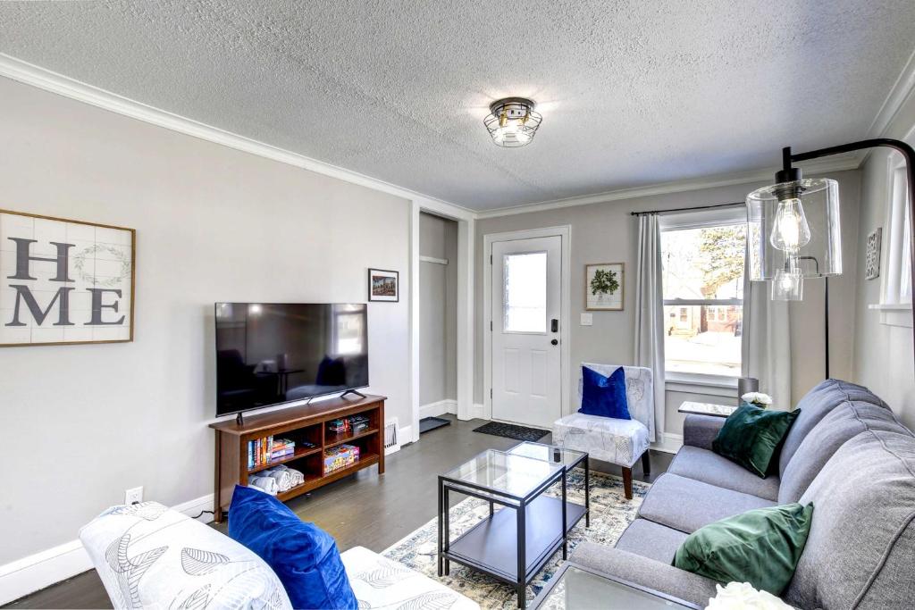 a living room with a couch and a tv at Rochester Vacation Rental about 1 Mi to Downtown in Rochester