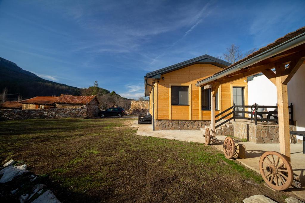 a small yellow house with a car parked in front of it at Apartman TALIJA in Pirot