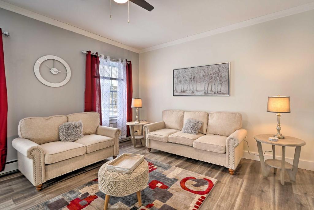 a living room with two couches and a table at Dog-Friendly Downtown Auburn Vacation Rental! in Auburn