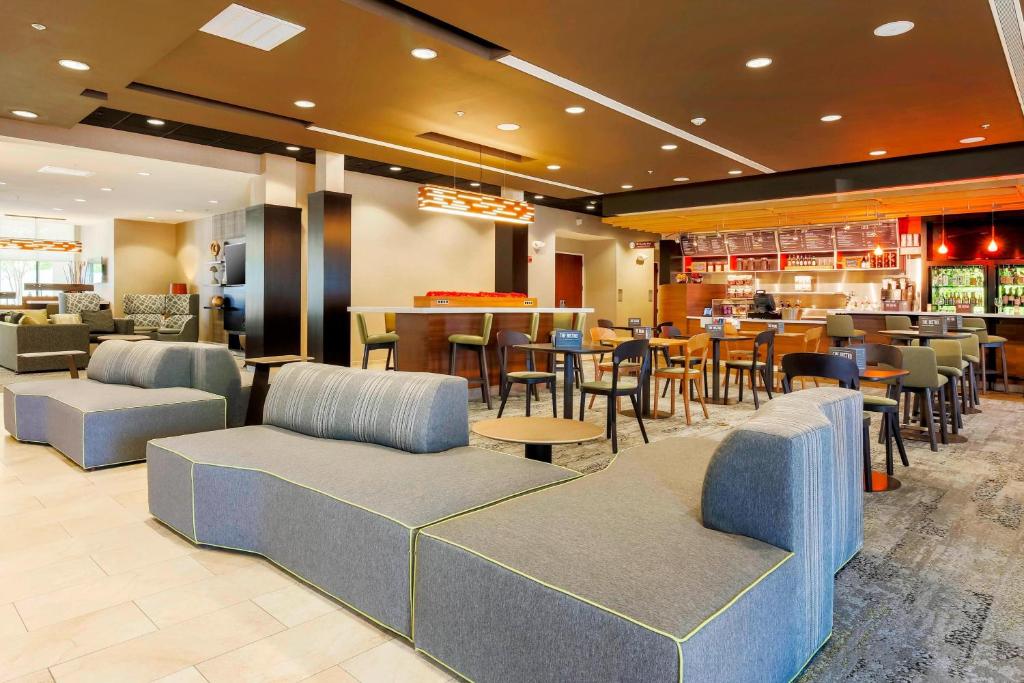 un ristorante con sedie e tavoli e un bar di Courtyard by Marriott Dallas Arlington South ad Arlington