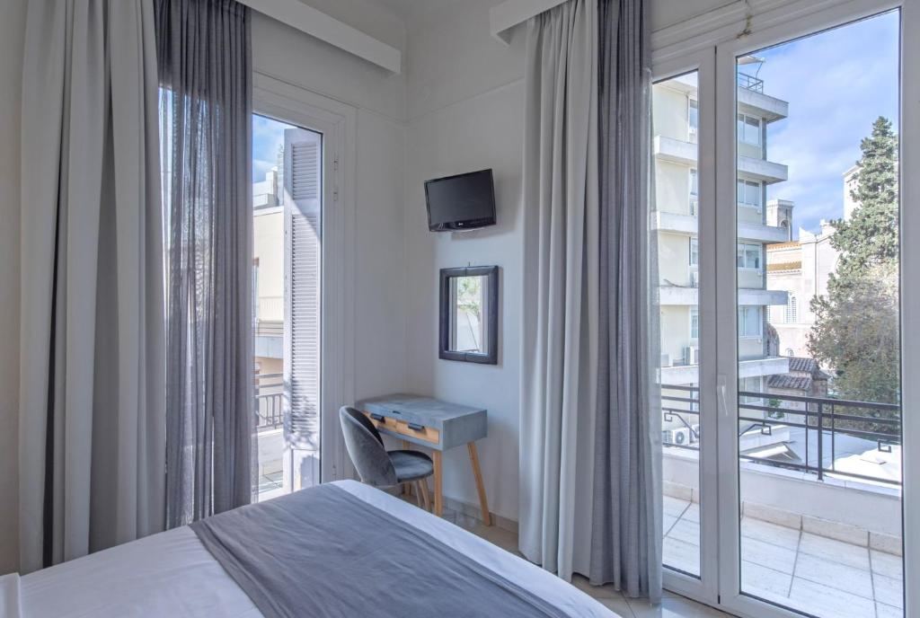 Postel nebo postele na pokoji v ubytování Kimon Hotel Athens