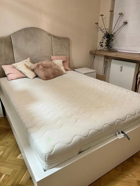 a bed in a room with a large mattress at Apartment by Chopina Street in Konin