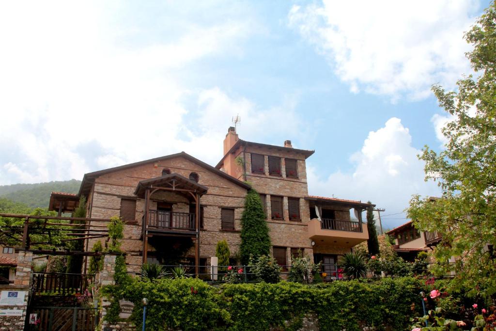 an old house with a tower on top of it at Archontiko Athina in Koumariá