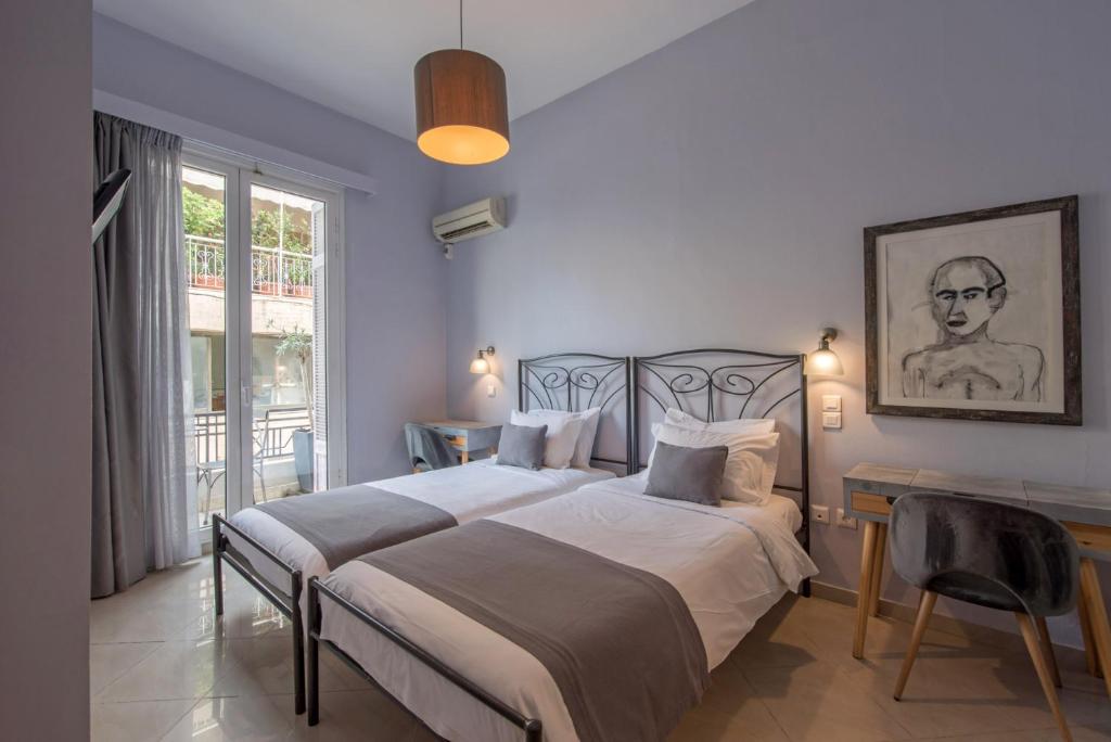 Postel nebo postele na pokoji v ubytování Kimon Hotel Athens