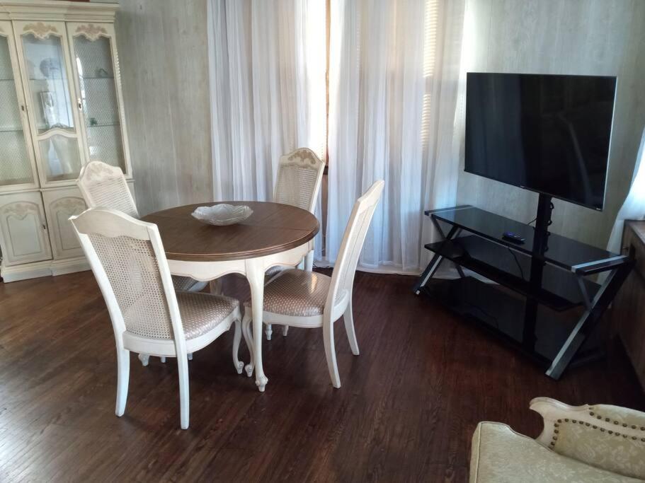 a dining room with a table and chairs and a television at Eddystone - Entire Property 