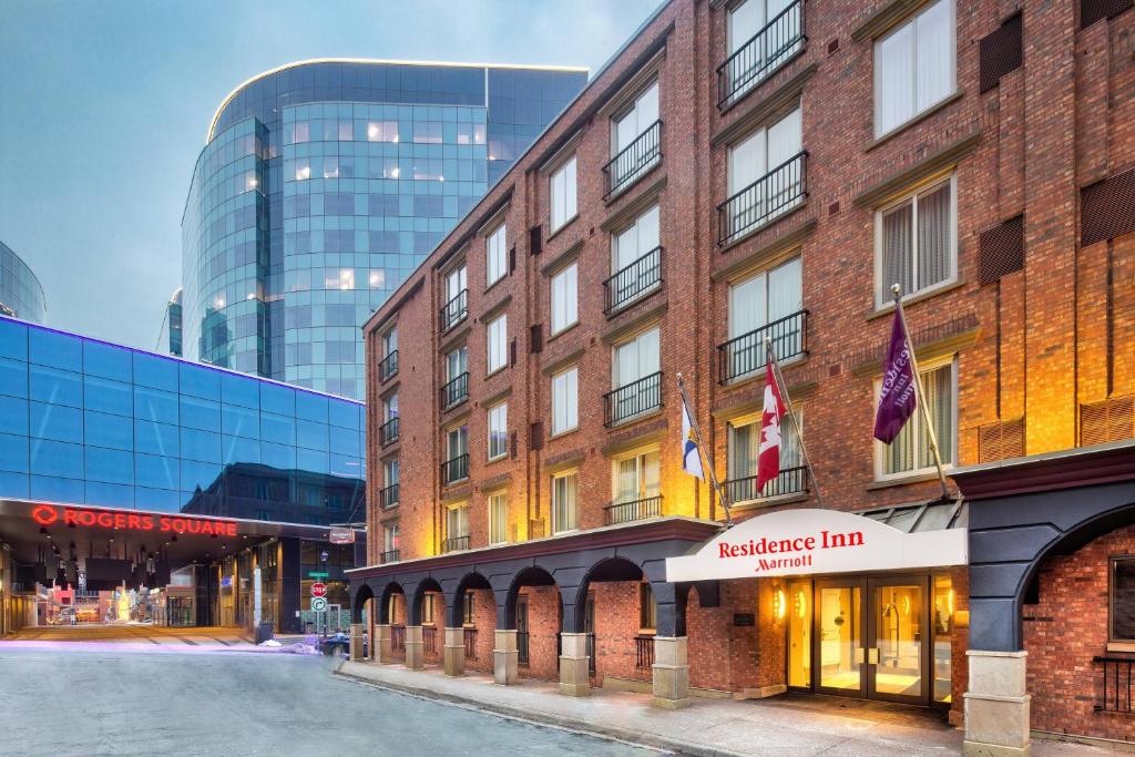 a brick building with a sign for a merchant inn at Residence Inn by Marriott Halifax Downtown in Halifax