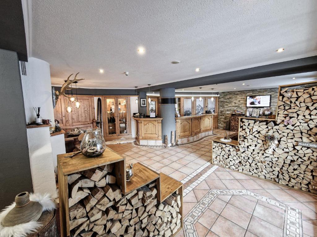 a large room with a pile of fire wood at Hotel Lärchenhof in Kaunertal