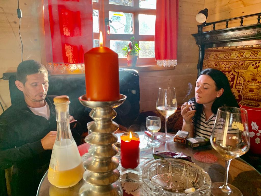 a man and a woman sitting at a table with a candle at Brvnare Mrkic in Kremna