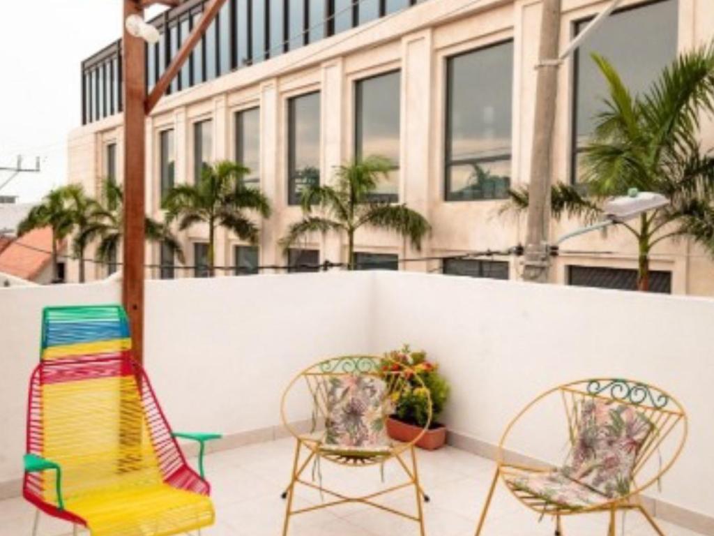 two chairs and a table on a patio with a building at Casa 39-33 in Cartagena de Indias