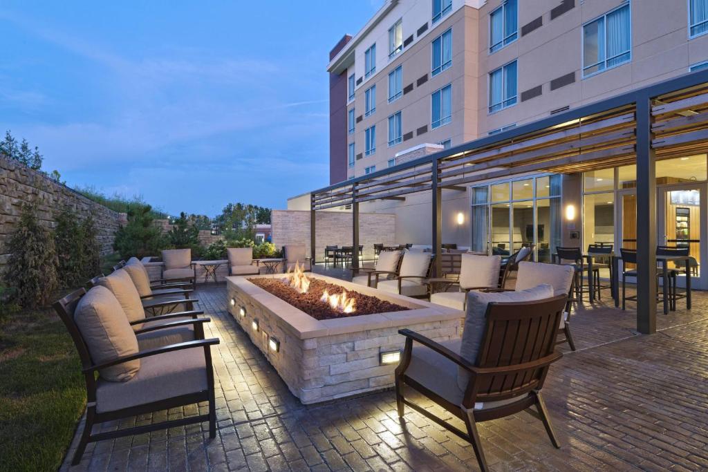 a patio with chairs and a fire pit in front of a building at Courtyard St. Louis Brentwood in Richmond Heights