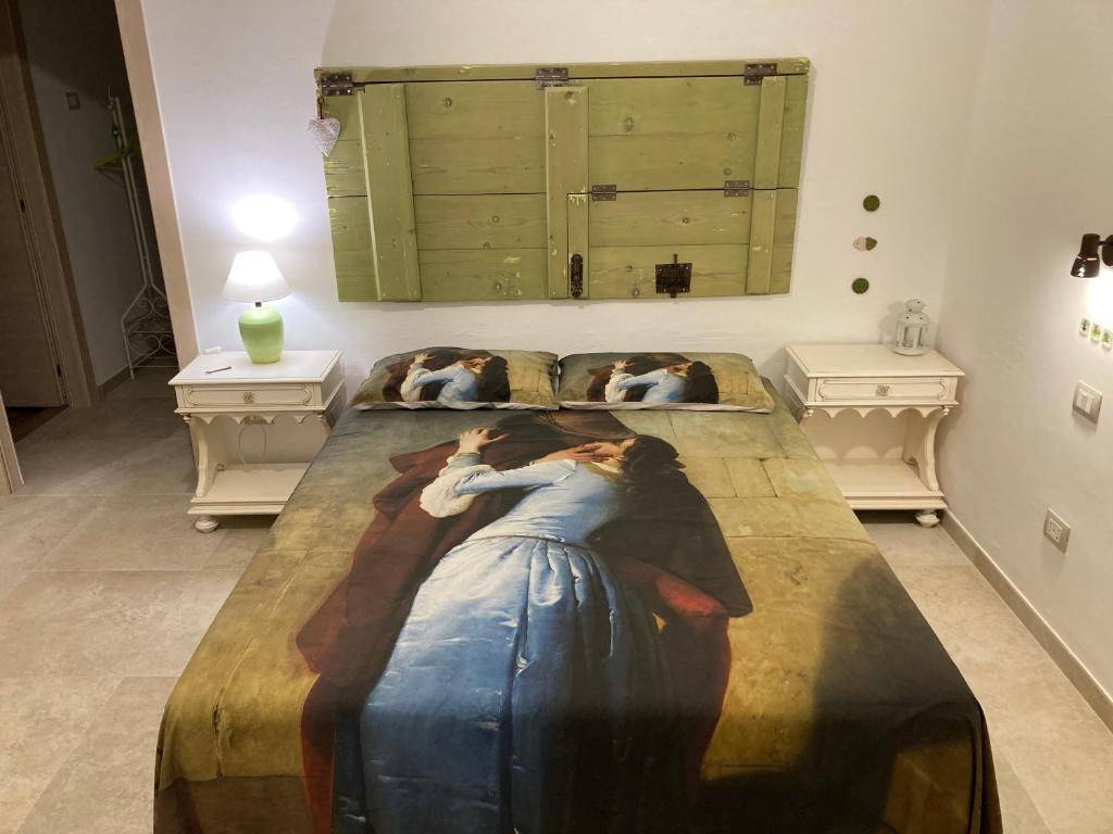 a bedroom with two beds with a painting on the wall at Il Casale Di Kevin in Monopoli