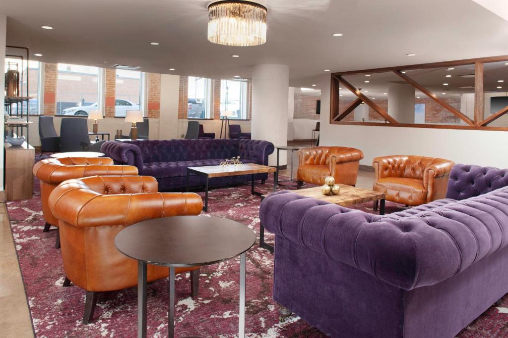 a living room with couches and chairs and tables at Fairfield Inn & Suites by Marriott Dallas Downtown in Dallas