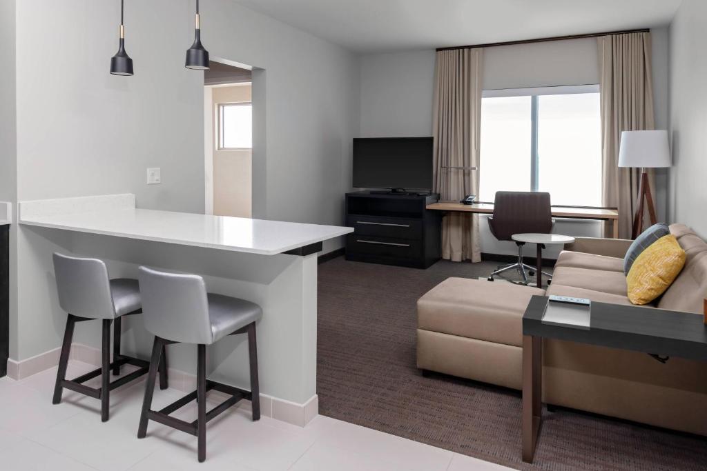 a kitchen and living room with a couch and a table at Residence Inn by Marriott Phoenix Mesa East in Ciela Grande Mobile Home Park