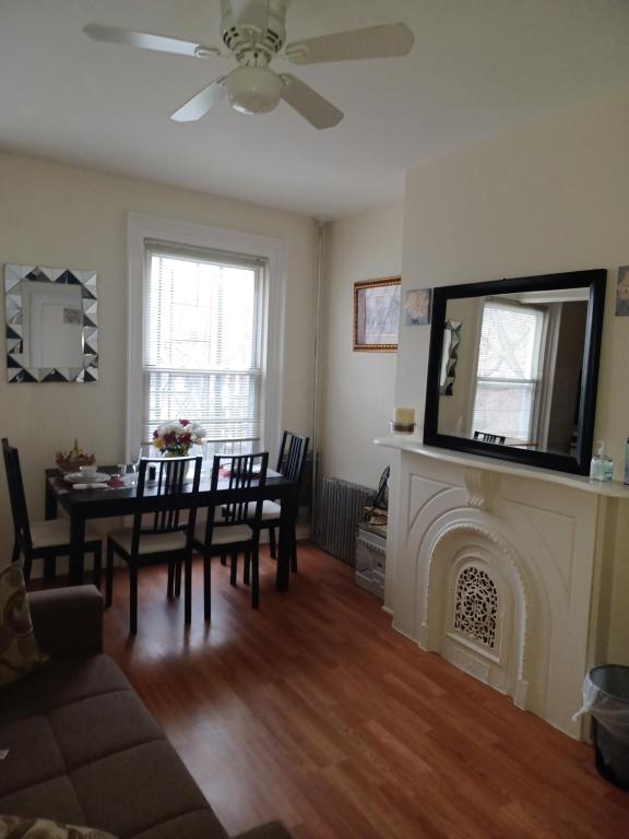 a living room with a table and a fireplace at The Heiress Hubb in Brooklyn