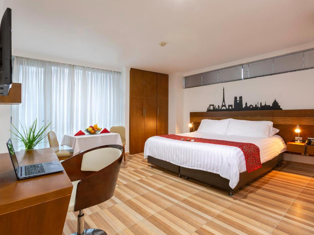 a hotel room with a bed and a desk and a computer at Hotel Vizcaya Plaza in Barrancabermeja