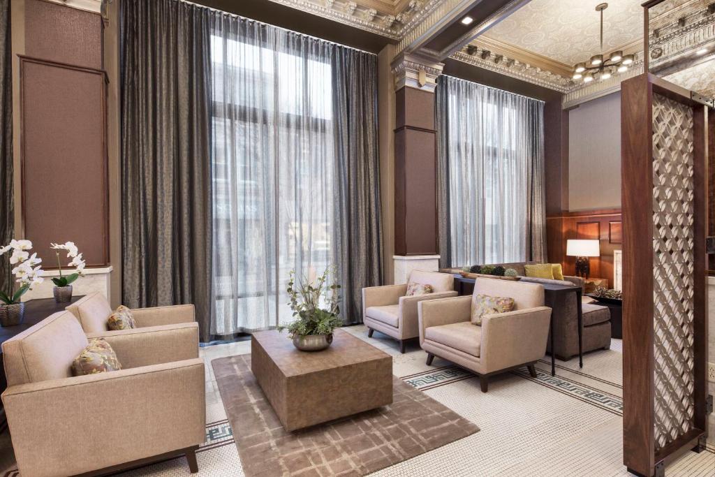 a lobby with a waiting room with couches and chairs at Courtyard by Marriott Cape Girardeau Downtown in Cape Girardeau