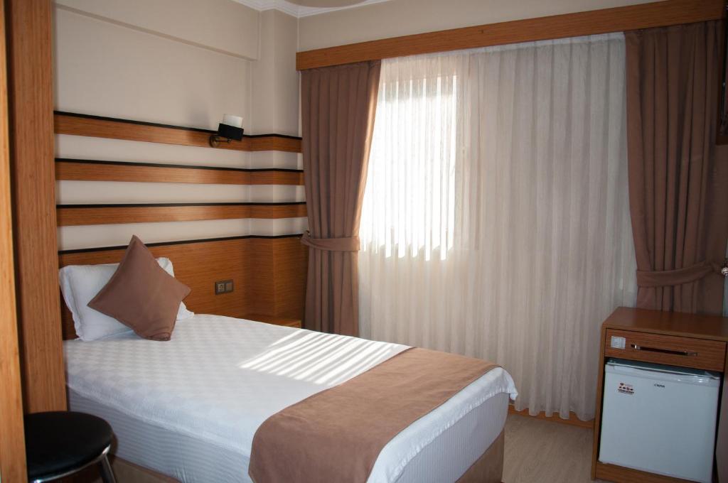 A bed or beds in a room at Quars Garden Hotel
